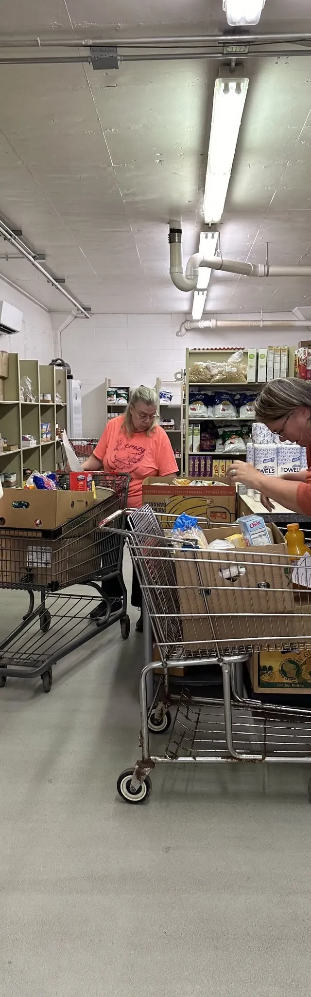 Volunteers filling carts from the shelves inside the Fort Atkinson Food Pantry
