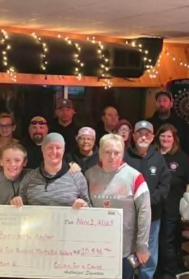 A large group of club members and families at a cheque presentation on club night